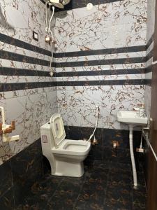 a bathroom with a toilet and a sink at The Little Braj Homestay in Mathura +53 photos