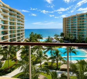 a view of the ocean from the balcony of a resort at Luxury Beachfront Condo at Del Canto Residences - Amazing Views! in Nuevo Vallarta