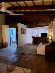 a living room with a bed and a pool table at Cozy Cork Cottage - Sleeps 4 in Beacon Bay