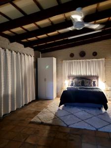 a bedroom with a bed and a ceiling fan at Cozy Cork Cottage - Sleeps 4 in Beacon Bay