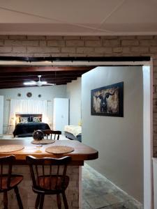 a living room with a table and a bedroom at Cozy Cork Cottage - Sleeps 4 in Beacon Bay