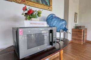 a television on a table with a blue object on top of it at Bunut Bungalow in Nusa Penida