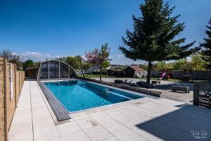 a swimming pool in a yard with a tree at San Marco - Na Brněnské ulici in Mutěnice