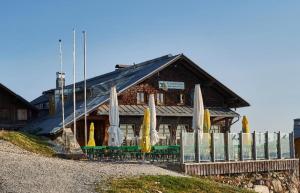 a building with closed umbrellas in front of it at Arberschutzhaus in Bayerisch Eisenstein