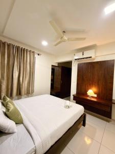 a bedroom with a large bed and a window at The Staying Co in Bangalore