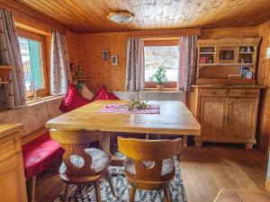 a dining room with a wooden table and chairs at Chalet near Passthurn Ski Area Kitzbühel in Mittersill