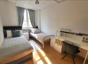 a bedroom with a bed and a desk and a couch at Tolle Stadtwohnung in Darmstadt