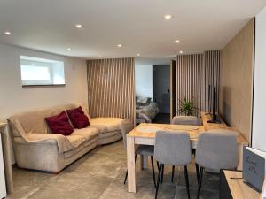 a living room with a couch and a table at Les champs étoilé in Morschwiller