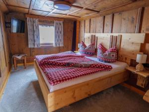 a bedroom with a bed in a wooden cabin at Chalet near Passthurn Ski Area Kitzbühel in Mittersill