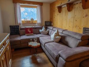 a living room with a couch and a table at Chalet near Passthurn Ski Area Kitzbühel in Mittersill