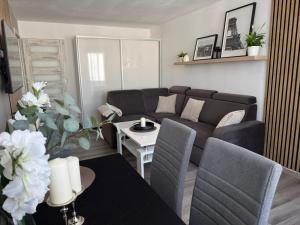 a living room with a couch and a table at Incanto Apartament os Kopernika in Starogard Gdański