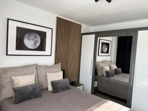 a bedroom with a bed and a bed and a mirror at Incanto Apartament os Kopernika in Starogard Gdański