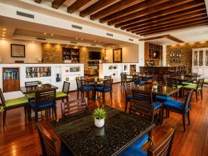 a restaurant with tables and chairs in a room at Luxury Beachfront Condo at Del Canto Residences - Amazing Views! in Nuevo Vallarta
