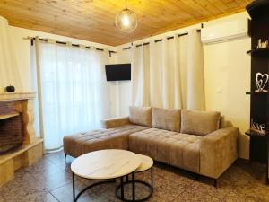 a living room with a couch and a table at Elite Suites in Afitos