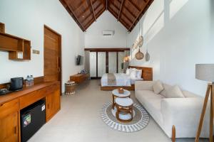 a living room with a couch and a bed at Nayandra Uluwatu in Uluwatu