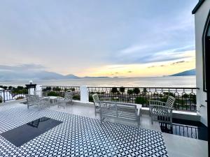 a balcony with chairs and a view of the ocean at EuroDana Palace Hotel in Danang