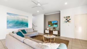 a living room with a couch and a table at Wave Whisperer Retreat in Woorim