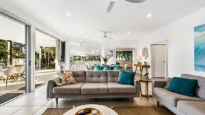 a living room with a couch and a table at Wave Whisperer Retreat in Woorim +16 photos