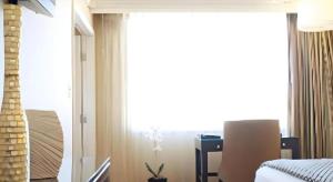 a bedroom with a bed and a large window at Harrahs Hotel Reno in Reno