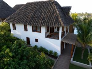an aerial view of a house with a thatched roof at Eco Resort WildLand - Zanzibar in Bwejuu