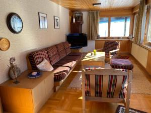 a living room with a couch and a tv at Haus Margret in Mellau
