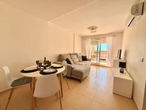a living room with a table and a couch at Condado de Alhama La Isla 11SV2F in El Romero