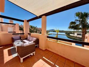 a balcony with furniture and a view of the water at Condado de Alhama La Isla 11SV2F in El Romero