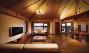 a living room with a couch and a table at Eldorado Resort in Sinan
