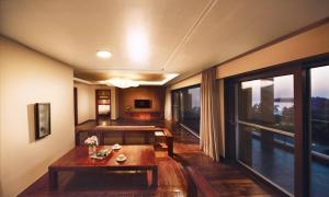 a living room with a table and a large window at Eldorado Resort in Sinan