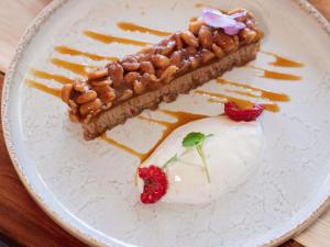 a white plate with a piece of pie and strawberries at ibis Styles Avignon Sud in Avignon
