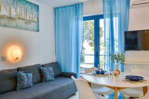 a living room with a couch and a table at Apartments Miki in Donja Klada