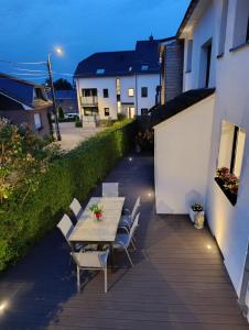 a table and chairs on a patio at night at Ferienhaus Lorea in Bütgenbach in Butgenbach