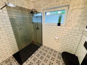 a bathroom with a shower and a window at RAJSKIE REZYDENCJE-Antresola Czarna,Antresola Biała in Bilcza +35 photos
