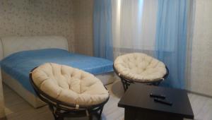 a hospital room with a bed and two stools at Apartment on Chapaeva in Borisov