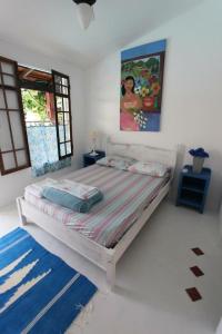 Säng eller sängar i ett rum på Vila Luiza Ubatuba