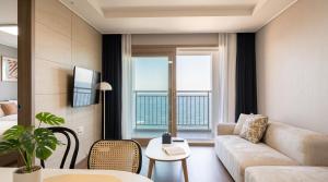 a living room with a couch and a large window at Urbanstay Sokcho beach C in Sokcho