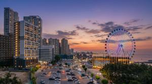 a city with a ferris wheel and a city at Urbanstay Sokcho beach C in Sokcho