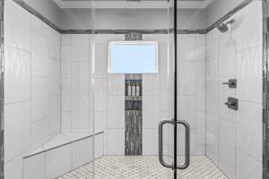 a shower with a glass door in a bathroom at The Elevated Spoonbill Dog-Friendly Beach Retreat in Bolivar Peninsula +26 photos