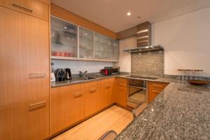 a kitchen with wooden cabinets and a counter top at Amselfluh in Arosa