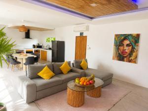 a living room with a couch and a table with fruit on it at Oh’lala - 3 BR Pool Villa in Ban Tai +10 photos
