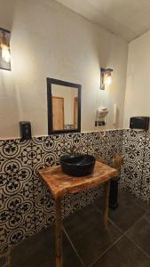 a bathroom with a sink on a bench with a mirror at Ruina Glamping in Mezgit +50 photos
