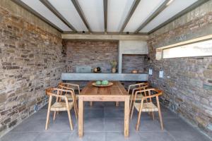a dining room with a wooden table and chairs at Tinos Prinos 3 in Agios Fokas