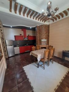 a kitchen and dining room with a table and chairs at Appement in Agadir nʼ Aït Sa