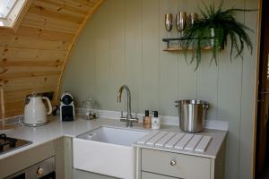 a kitchen with a sink and a counter top at Calmwater Hideaway in New Hey +162 photos