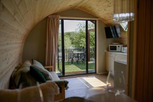 a living room with an open door to a patio at Calmwater Hideaway in New Hey