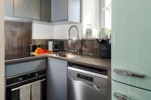 a kitchen with a sink and a dishwasher at Torre dei 7 Frati in Cefalù