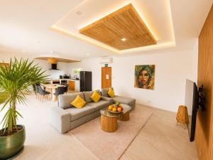 a living room with a couch and a table at Oh’lala - 3 BR Pool Villa in Ban Tai