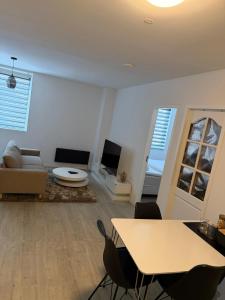 a living room with a table and a couch at Casaejon in Lelystad