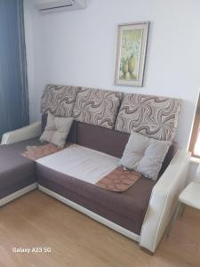 a futon bed in a living room with at Апартамент Нина in Byala