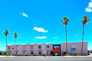 a pink building with palm trees in front of it at Sands Inn & Suites Lake Havasu City in Lake Havasu City +21 photos